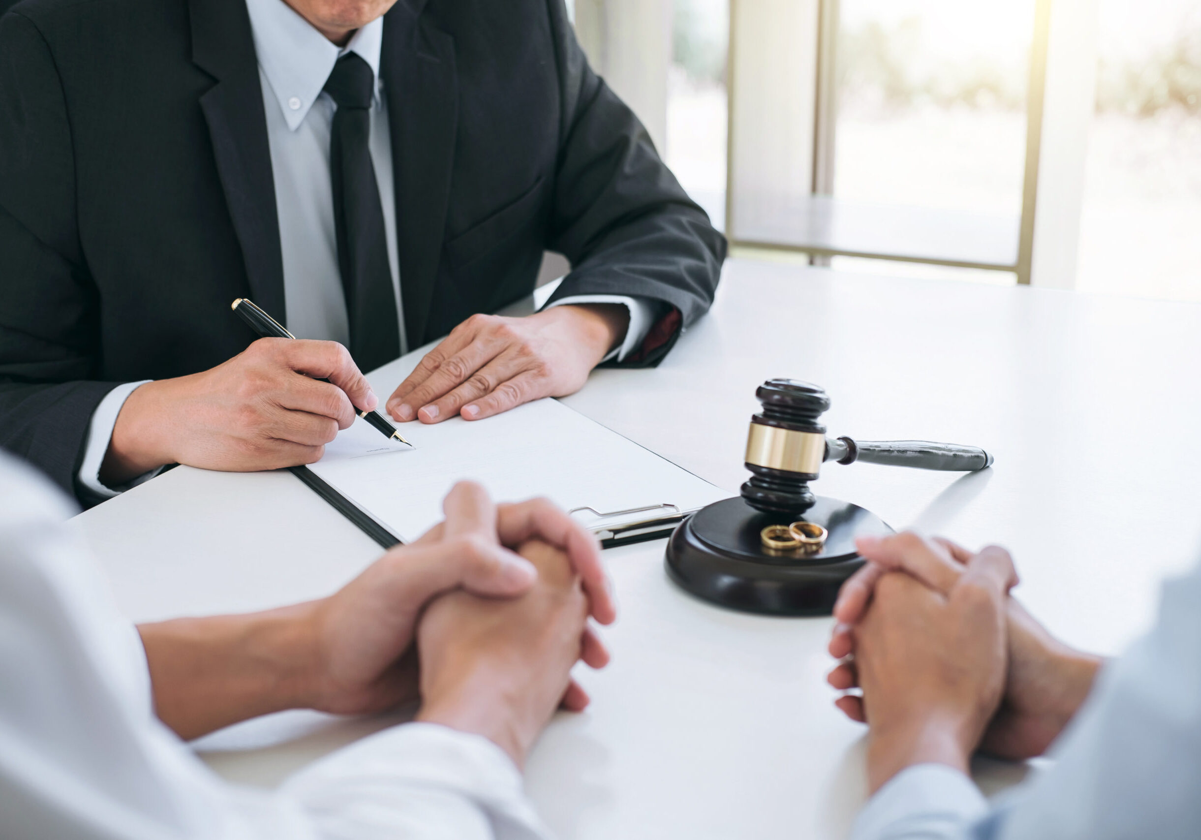 Agreement prepared by lawyer signing decree of divorce (dissolut Agreement prepared by lawyer signing decree of divorce (dissolution or cancellation) of marriage, husband and wife during divorce process with male lawyer or counselor and signing of divorce contract.
